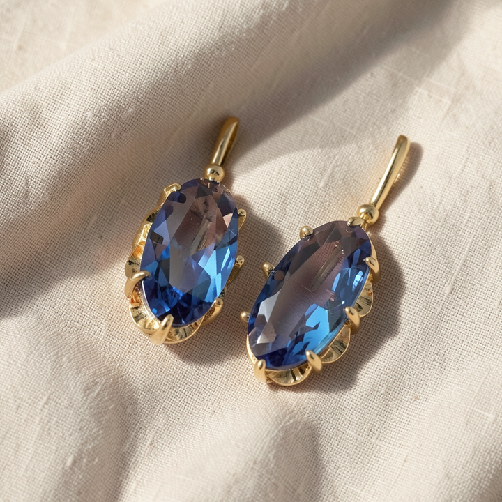 Goldene Blumen-Ohrringe mit blauem Saphir