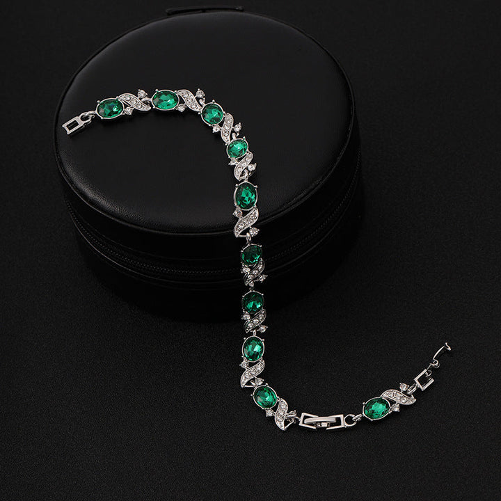 Silbernes Wellen-Kettenarmband mit grünem Stein